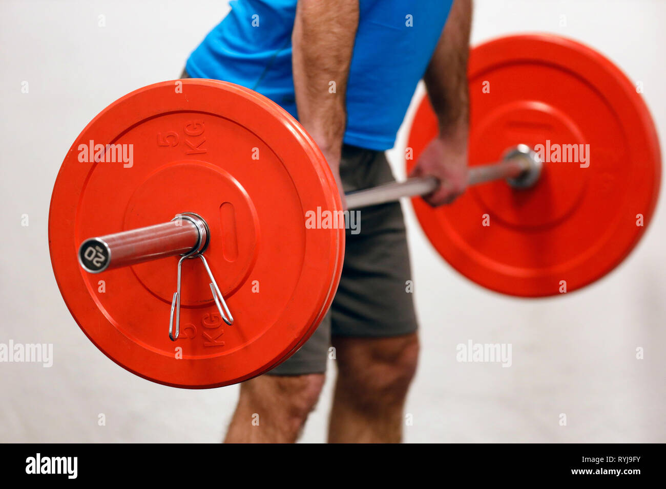 Man lifting weights in gym.  France. Stock Photo