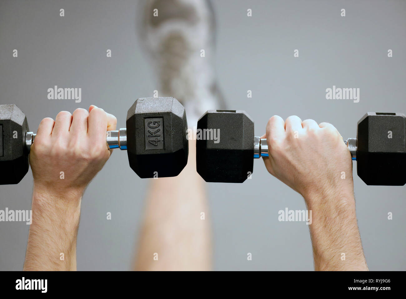 Man lifting weights in gym.  France. Stock Photo