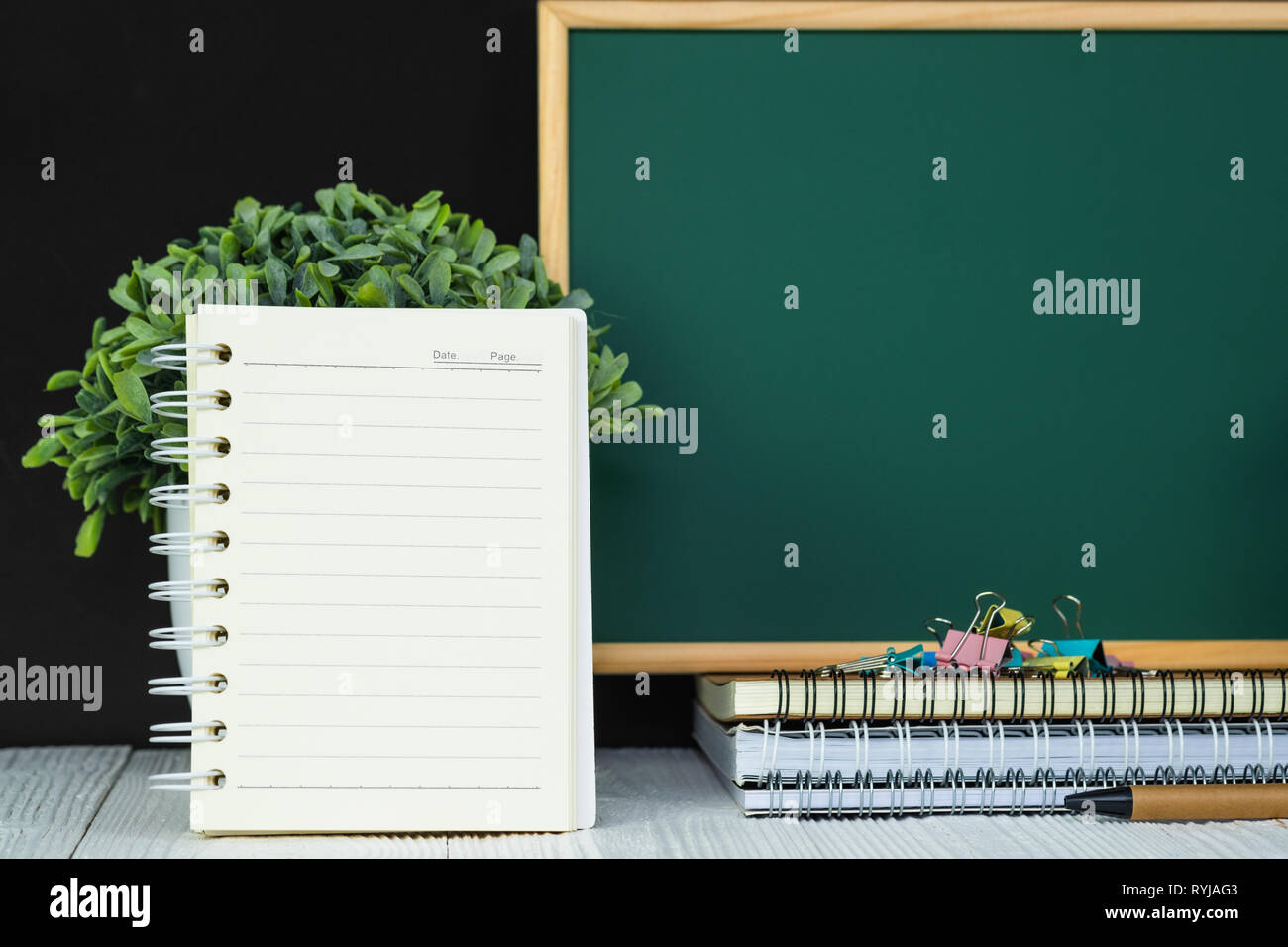 Back to school and education concept idea, green chalkboard with pile ...