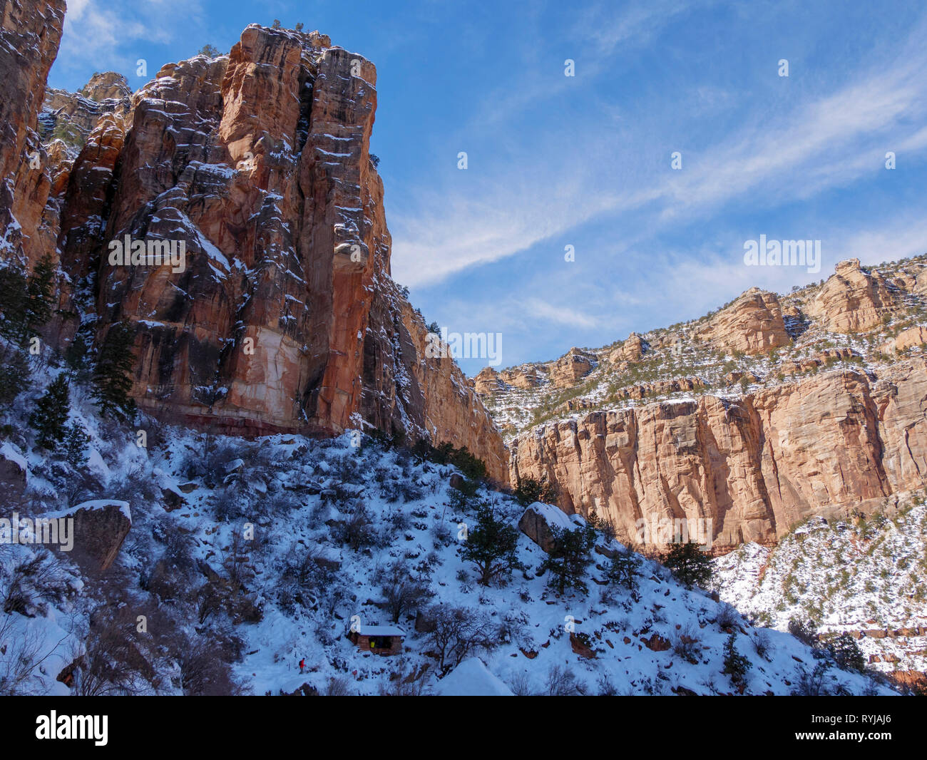 The towering canyon walls on the Bright Angel Trail. When the sun hit one wall, the heat melted ice and chunks of ice and rock came down with an amazi Stock Photo