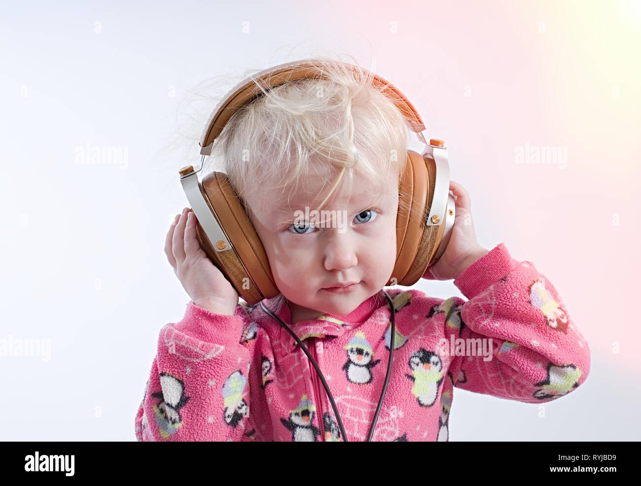 Baby child cute adorable toddler childhood headphones listening hires stock photography and
