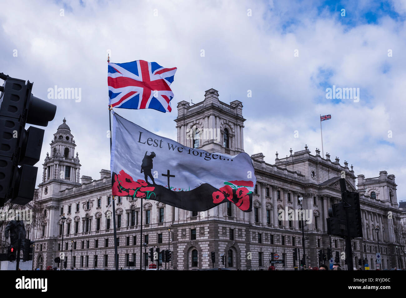 Lest We Forget & Union Jack flags flying over Whitehall, London, England, U.K. Stock Photo