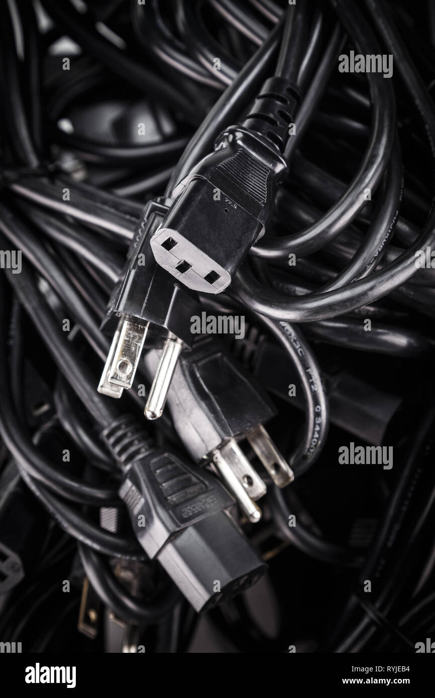 Black power cables cords in a pile (US 3-Prong For PC server many electric home office industrial appliance) Stock Photo