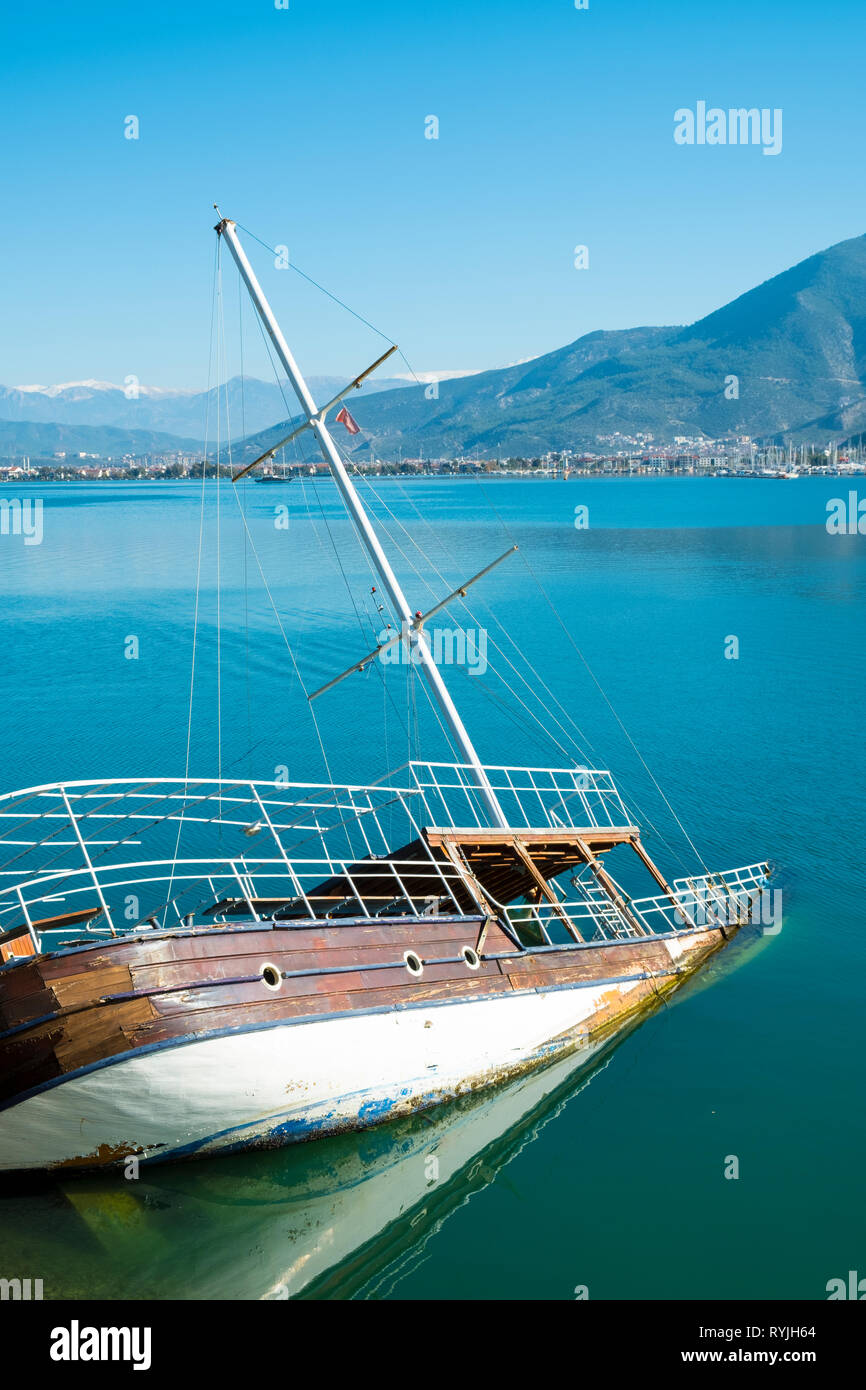 Sunken shipwreck boat in the sea off the coast of Fethiye, Turkey. Vertical Stock Photo