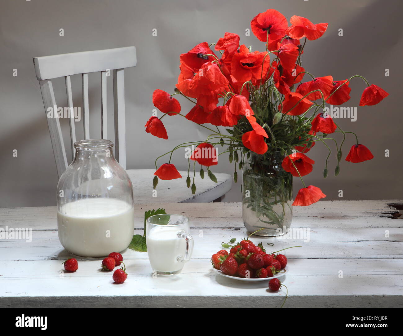 Still life with strawberries and a bouquet of poppies Stock Photo - Alamy