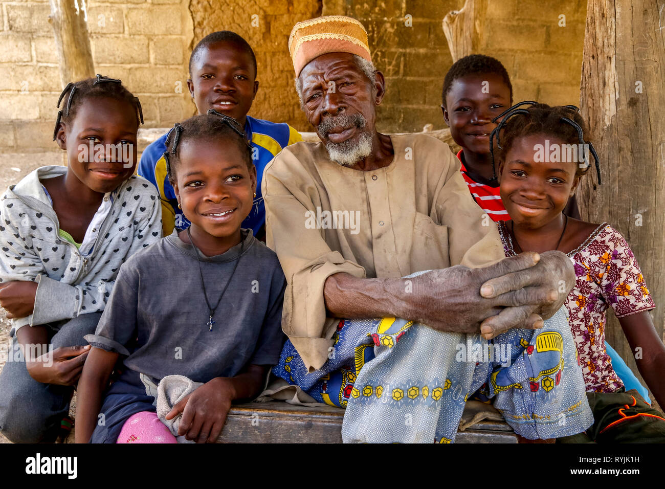 Children around their grandfather in Tenkodogo, Burkina Faso. Stock Photo