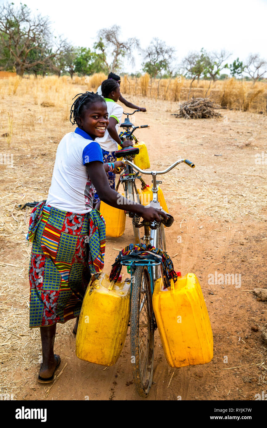 Girls fetching water in a village near Ouahigouya, Burkina Faso. Stock Photo