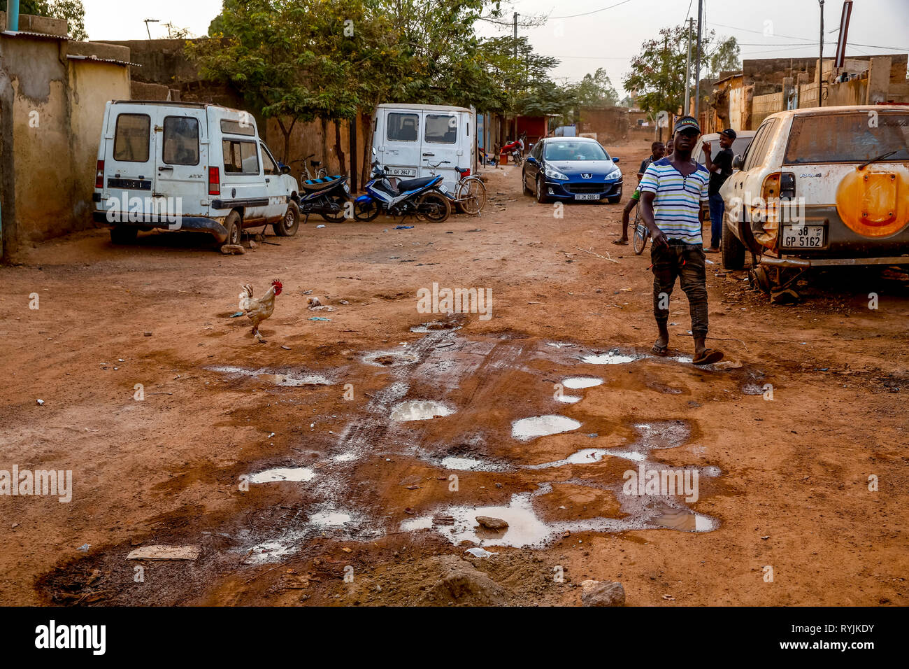 Pot-holed road in Ouagadougou, Burkina Faso. Stock Photo