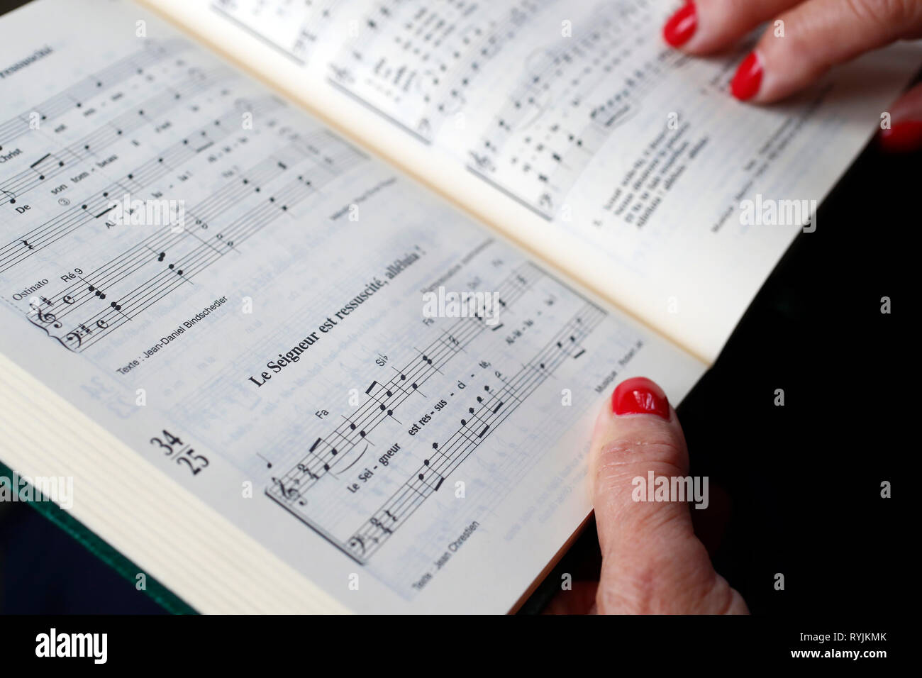 Woman reading Alleluia, a protestant Praise and Worship Songbook. Stock Photo