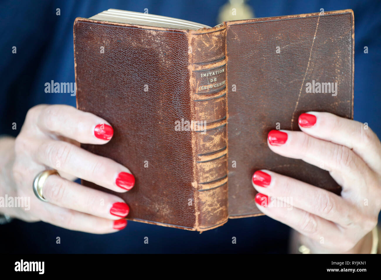 Woman reading and old christian book. Close-up. Stock Photo