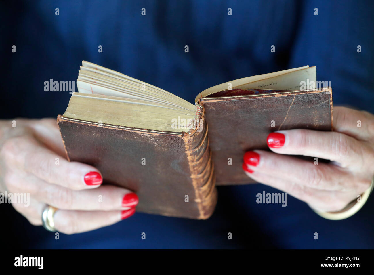 Woman reading and old christian book. Close-up. Stock Photo