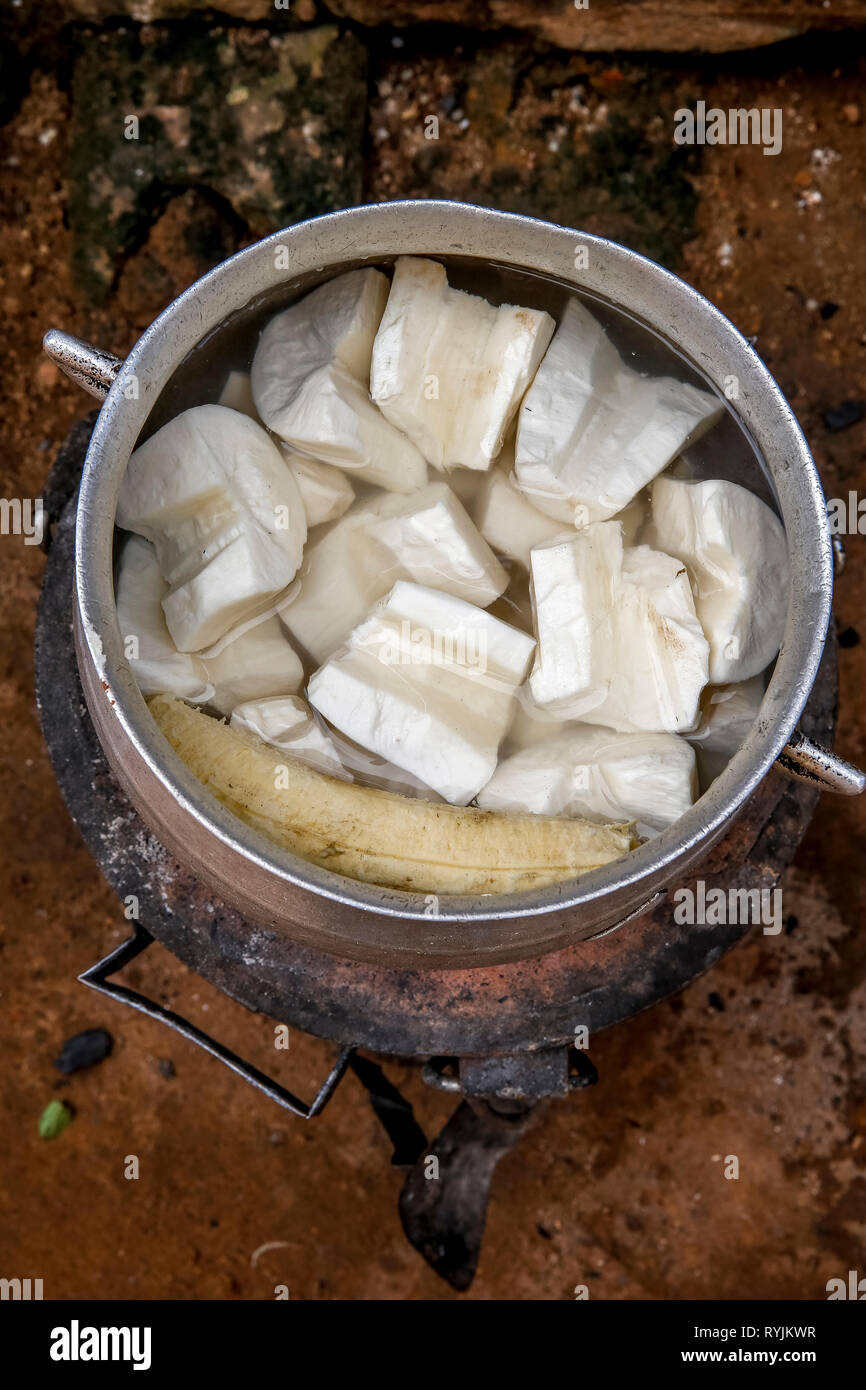 Traditional dish cooking in a village near Agboville, Ivory Coast. Yams mixed with plantain. Stock Photo