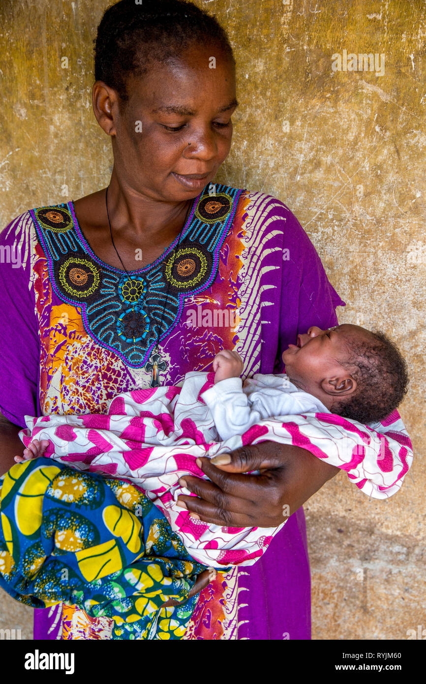 Mother holding baby near Agboville, Ivory Coast. Stock Photo