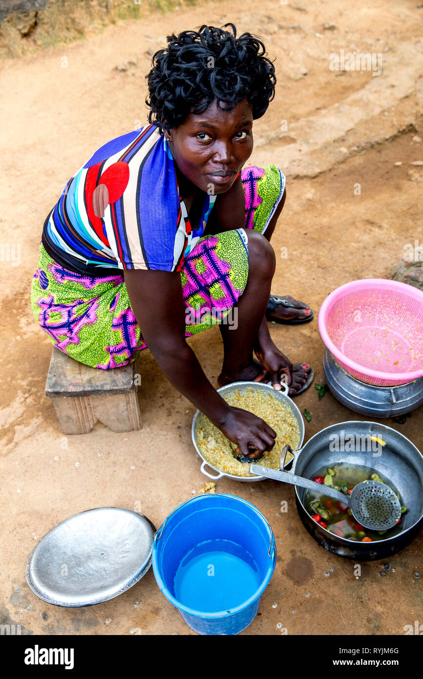 Village woman cooking near Agboville, Ivory Coast. Stock Photo