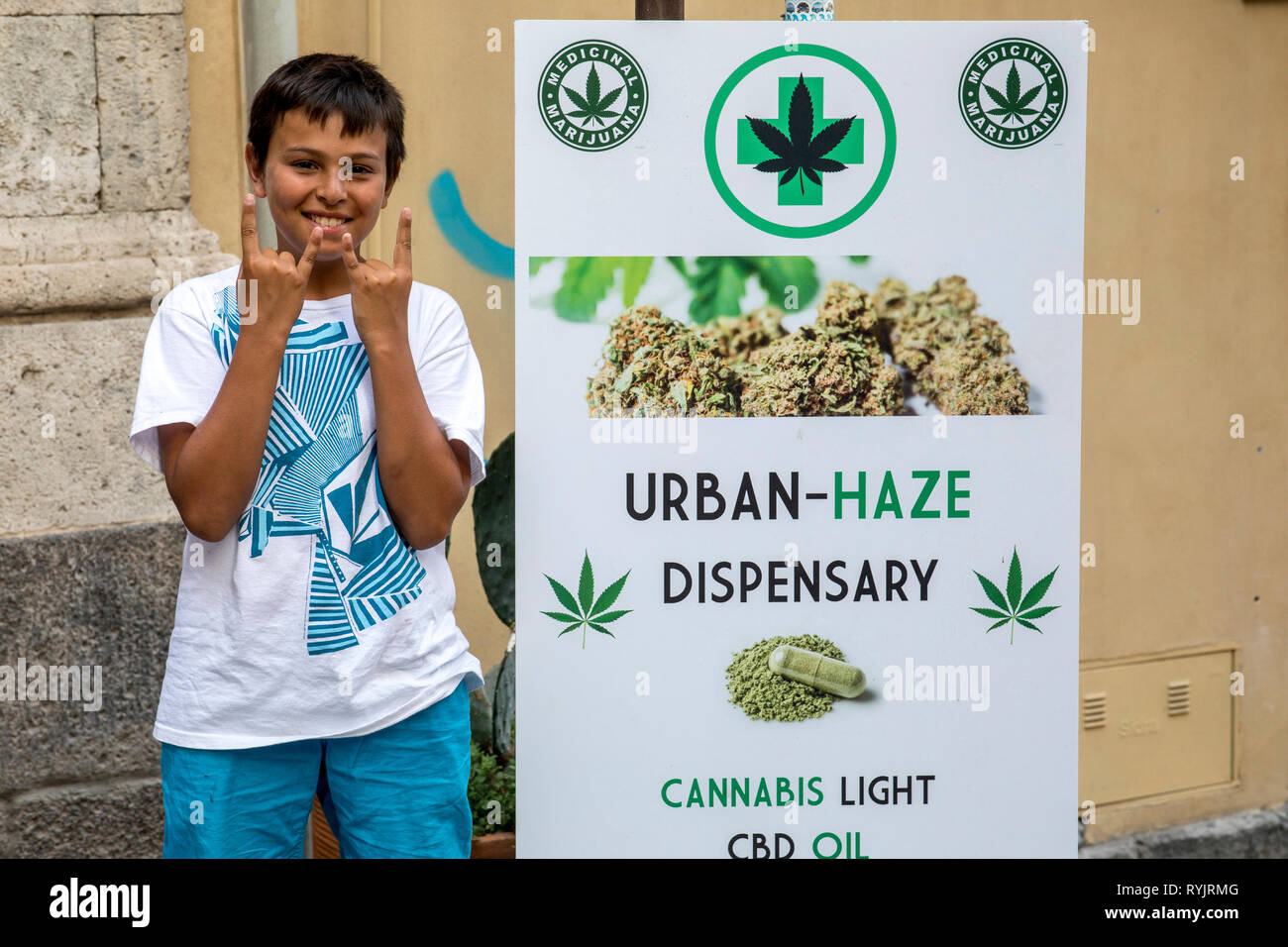 12-year-old boy standing near a cannabis shop in Catania, Sicily (Italy). Stock Photo