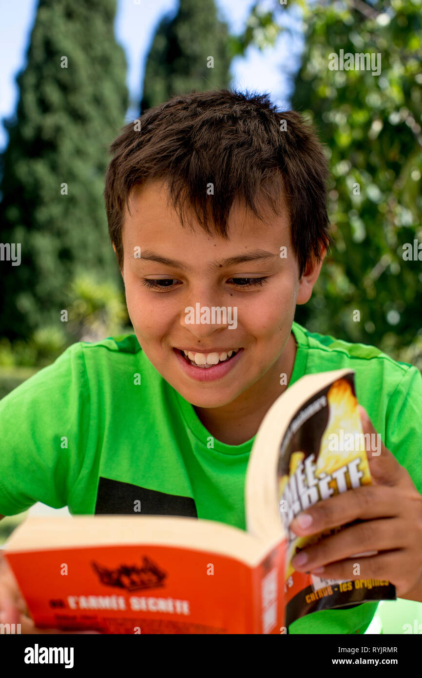 12-year-old boy reading a book in Sicily (Italy). Stock Photo