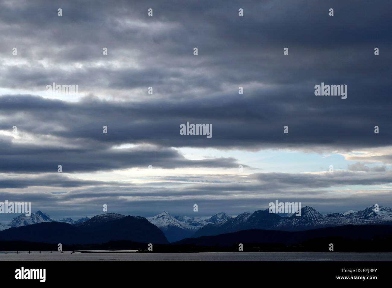 Cloudy sky over lake and mountains.  Molde. Norway. Stock Photo