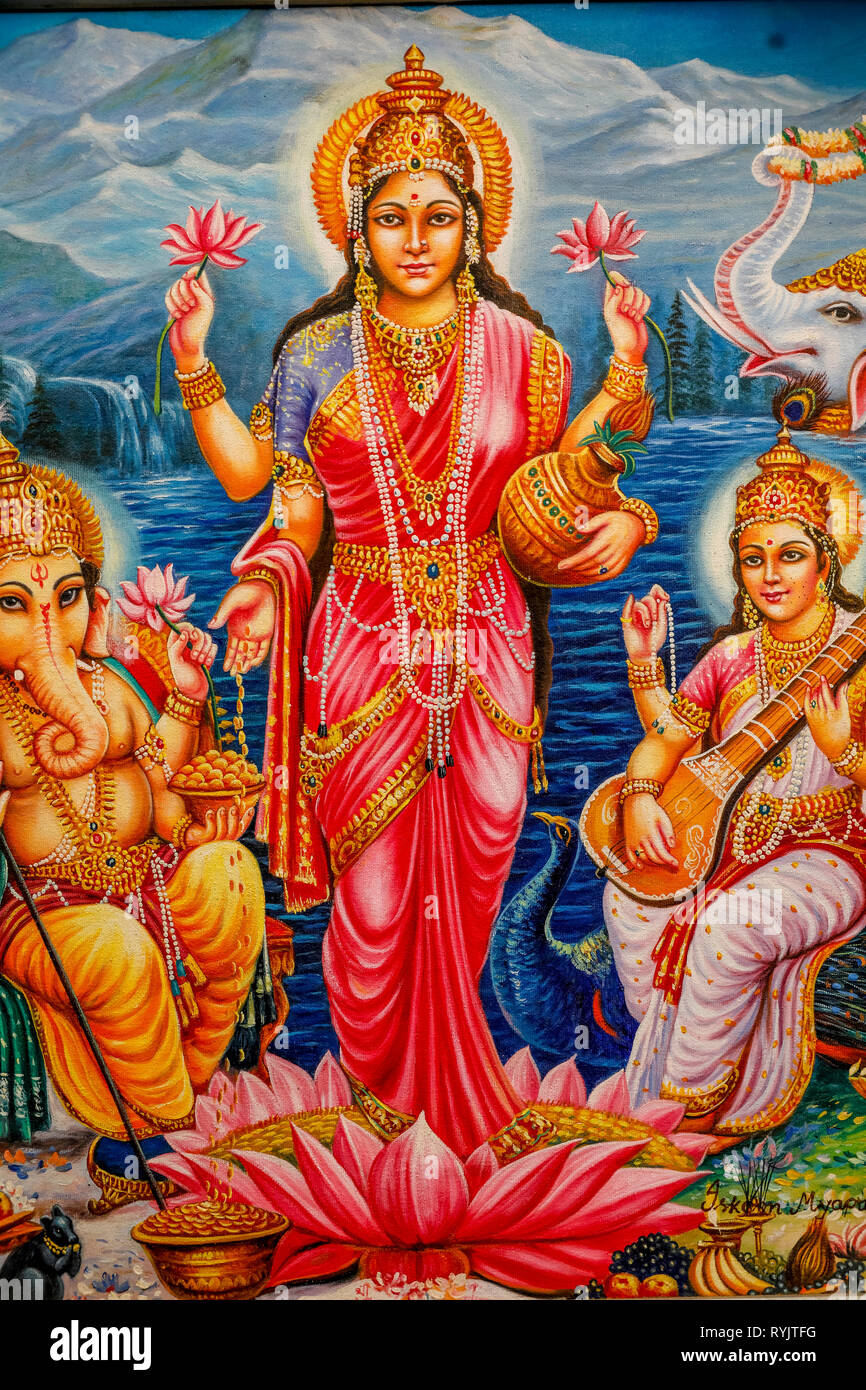 Hindu goddess Lakshmi surrounded by Ganesh and Saraswati. Bhaktivedanta manor, Watford, U.K. Stock Photo