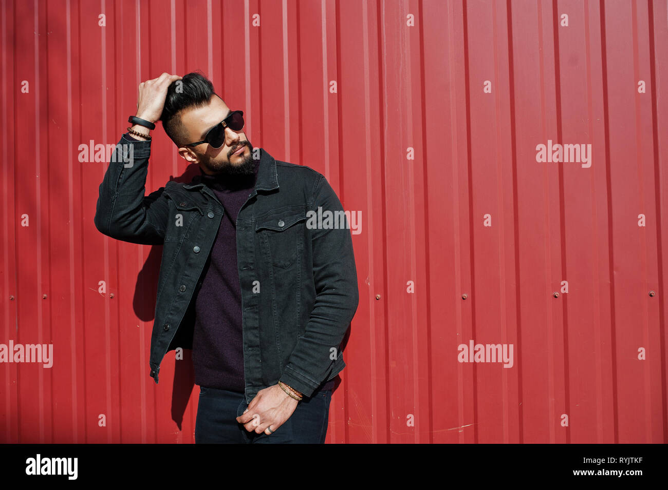 Fashion Arab Man Wear On Black Jeans Jacket And Sunglasses Posed Against Red Steel Wall Background Stylish And Fashionable Arabian Model Guy Stock Photo Alamy