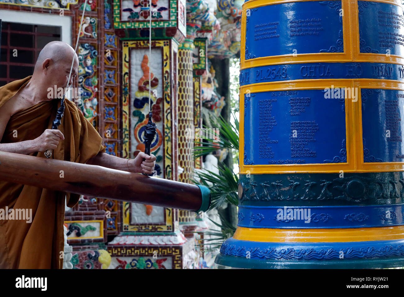 Ho Phap buddhist temple. Young monk ringing bell in monastery. Vung Tau. Vietnam. Stock Photo