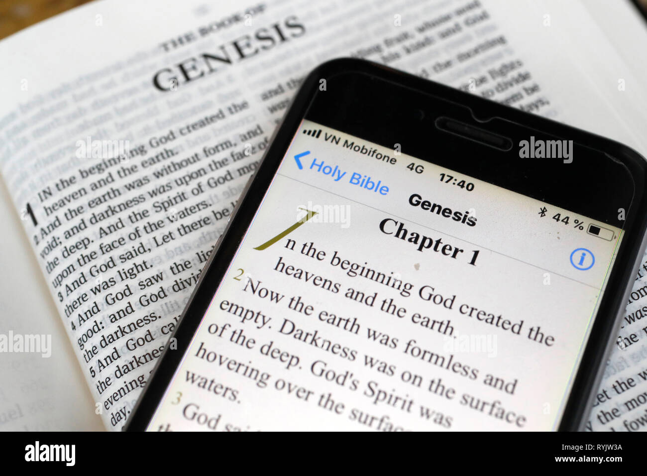 Paper Bible and digital Bible app on smartphone. The Old Testament