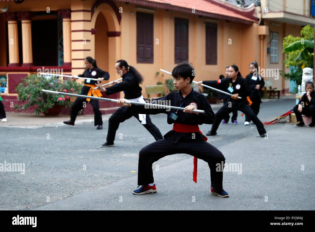 Boys practicing martial arts in a buddhist temple. Vung Tau. Vietnam. Stock Photo