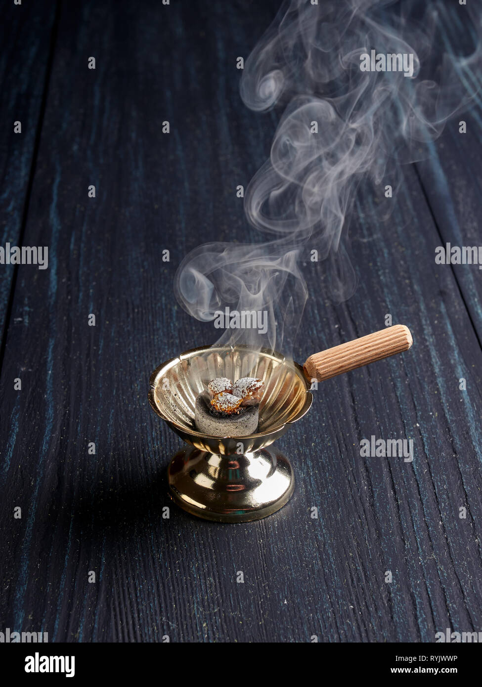 Burning incense in a simple Romanian orthodox censer or incense burner Stock Photo