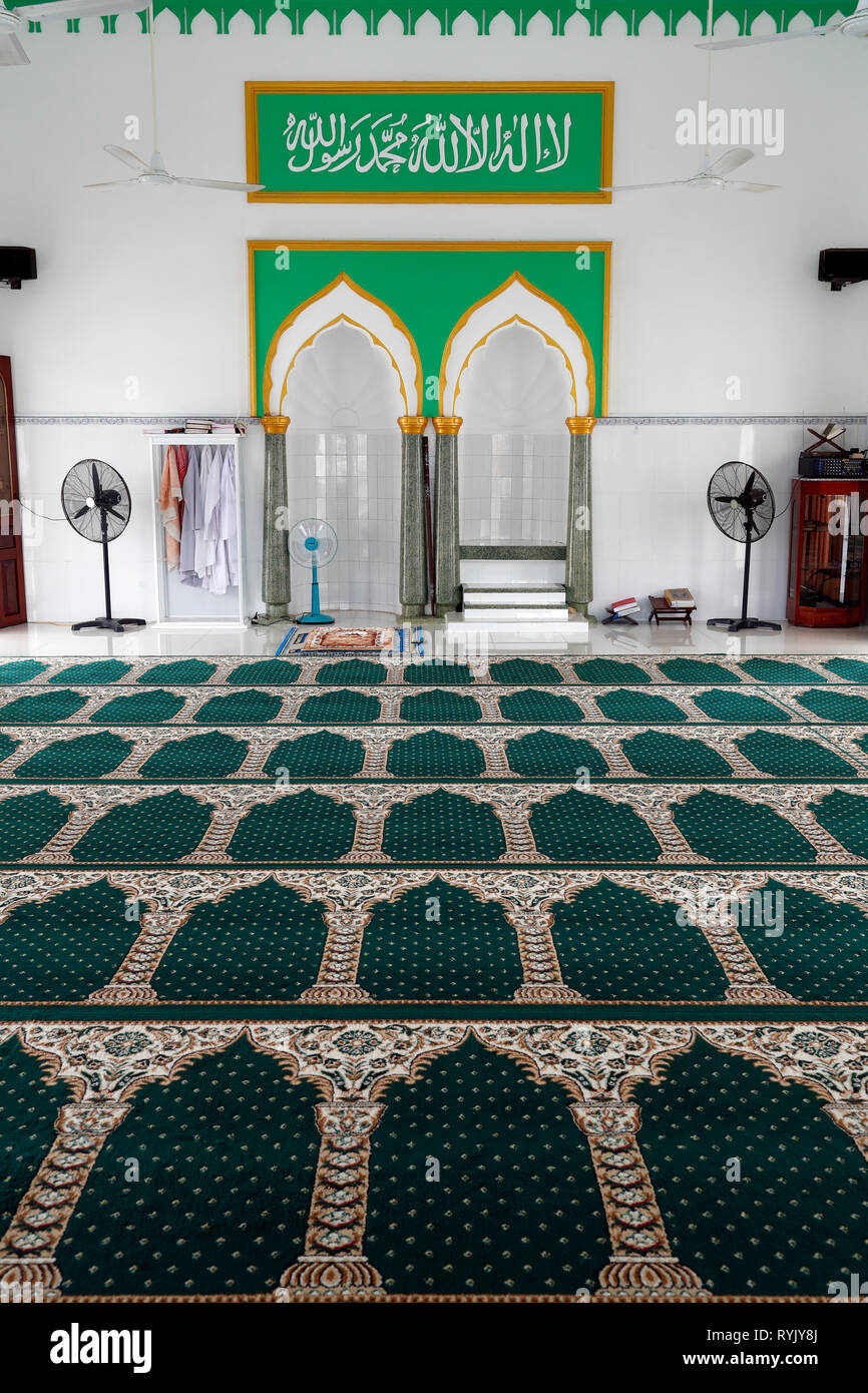 Masjid Al Ehsan mosque.  Prayer hall with minbar and mihrab.  Green carpet.  Chau Doc. Vietnam. Stock Photo