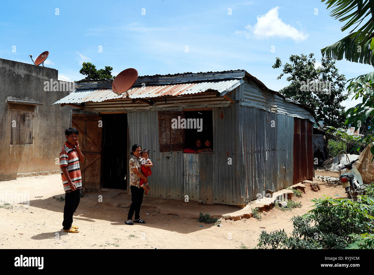 Poor vietnamese family living in a small barrack consists of scrap metal. Dalat. Vietnam. Stock Photo