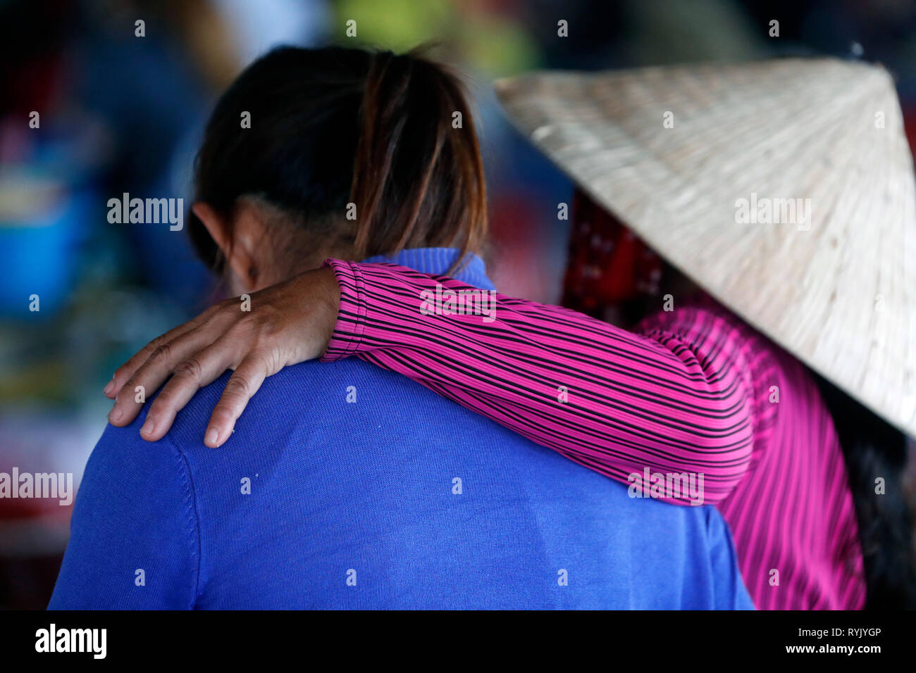 Two female friends. Hand on shoulder. Ha Tien. Vietnam. Stock Photo