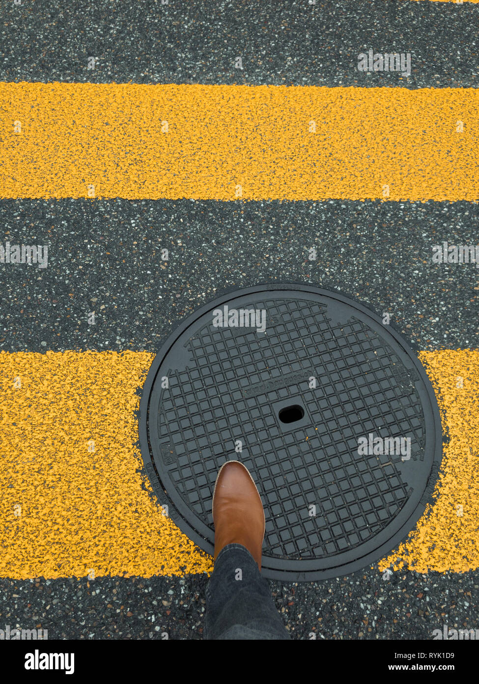 pedestrian sign on pavement with feet Stock Photo