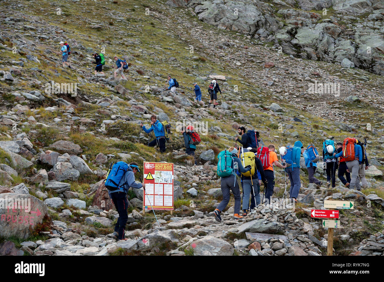 Alpinists during the ascent of Mont Blanc along the regular route via Gouter Refuge.  Local Bye-Law. Regulated Access to Mont Blanc sign.  France. Stock Photo