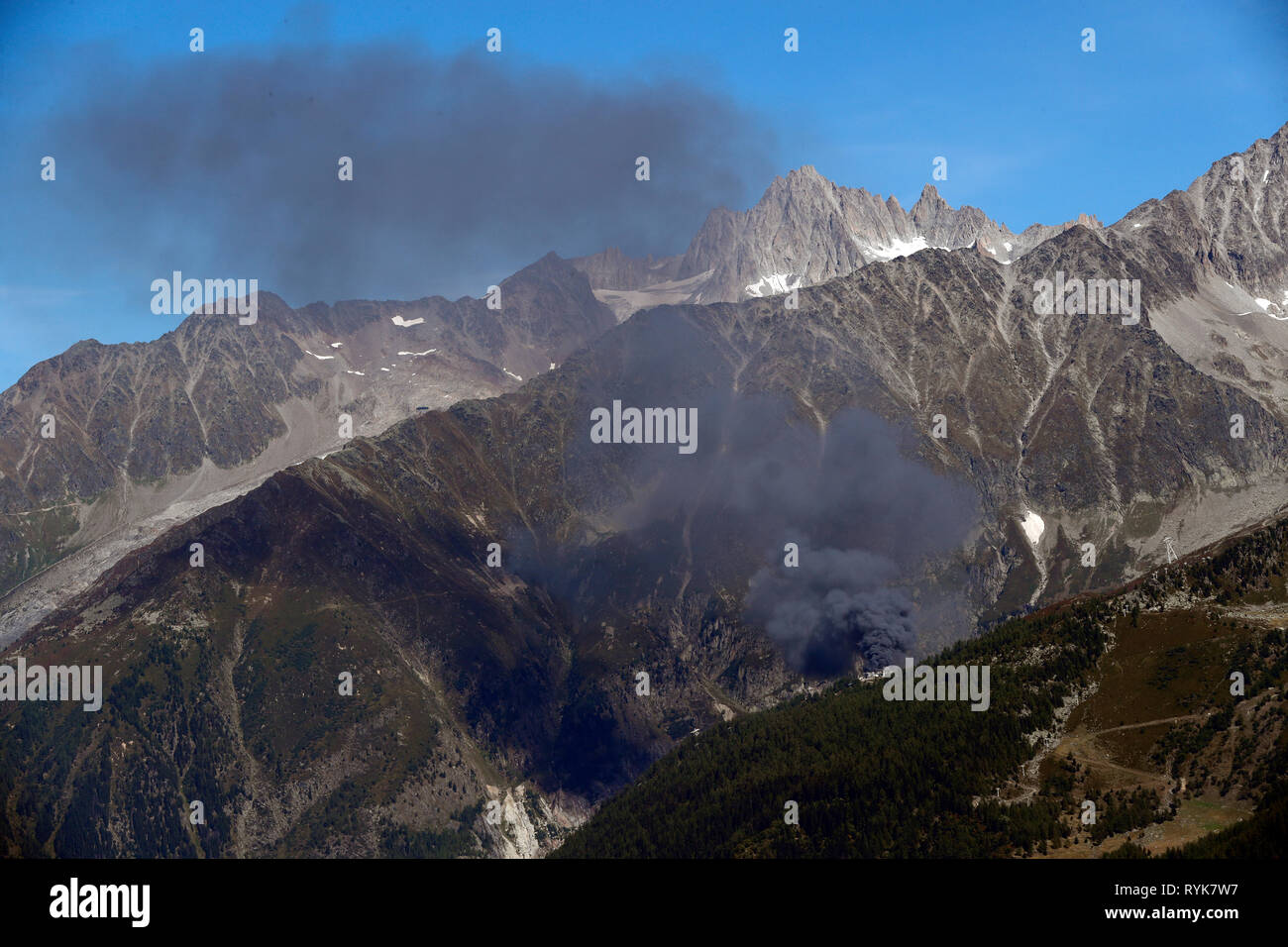 Chamonix Valley, French Alps. The Aiguille Verte seen from Planpraz.  Fire on the Grand Montets cable station.  France. Stock Photo