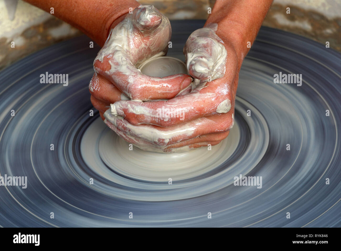 Old Domancy craft festival. The hands of a potter shaping clay at a potters wheel.  France. Stock Photo