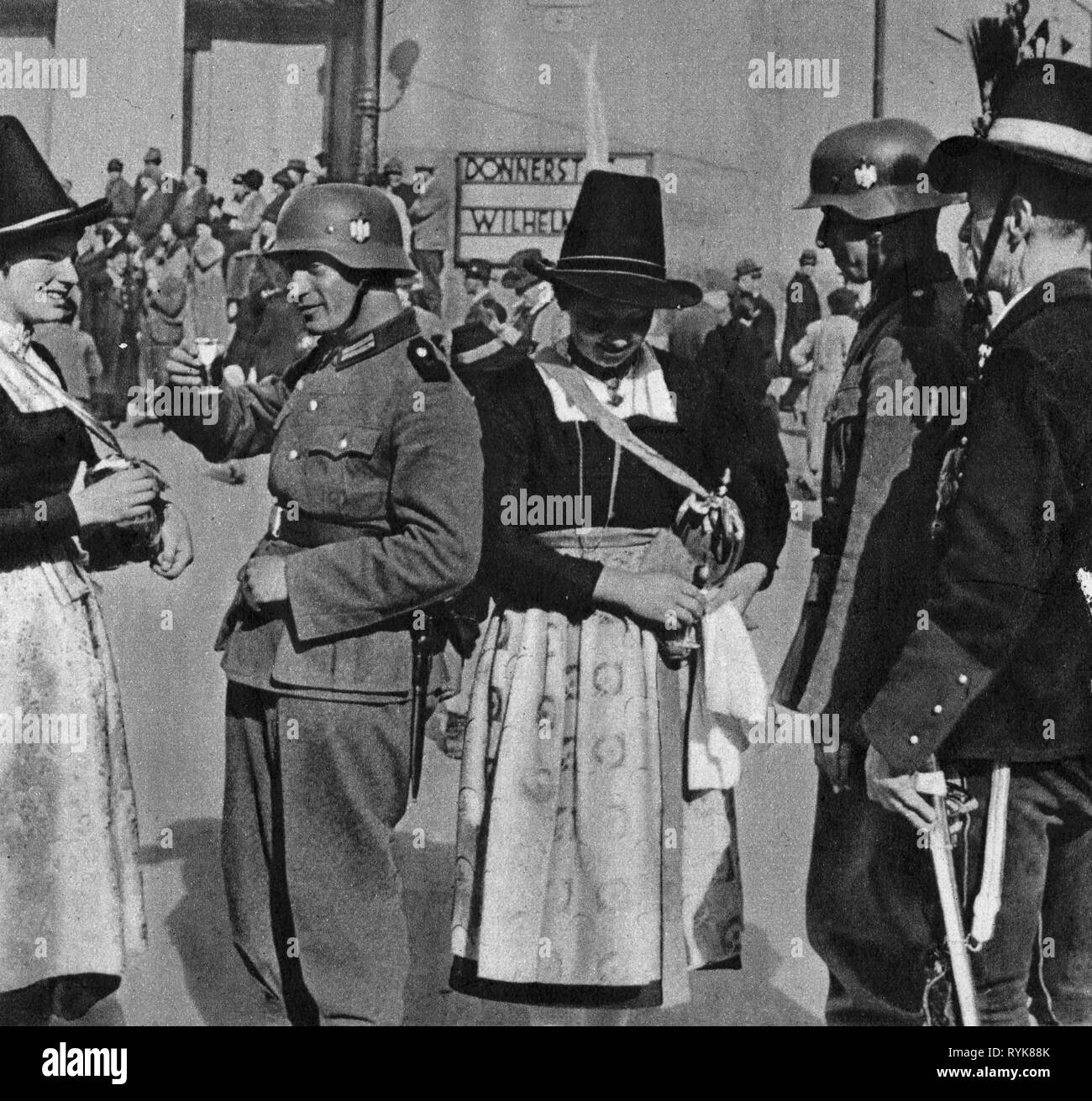 Nazism / National Socialism, politics, annexation of Austria 1938, march-in of the German Wehrmacht, welcoming of soldiers with schnaps, Innsbruck, Austria, 12.3.1938, Additional-Rights-Clearance-Info-Not-Available Stock Photo