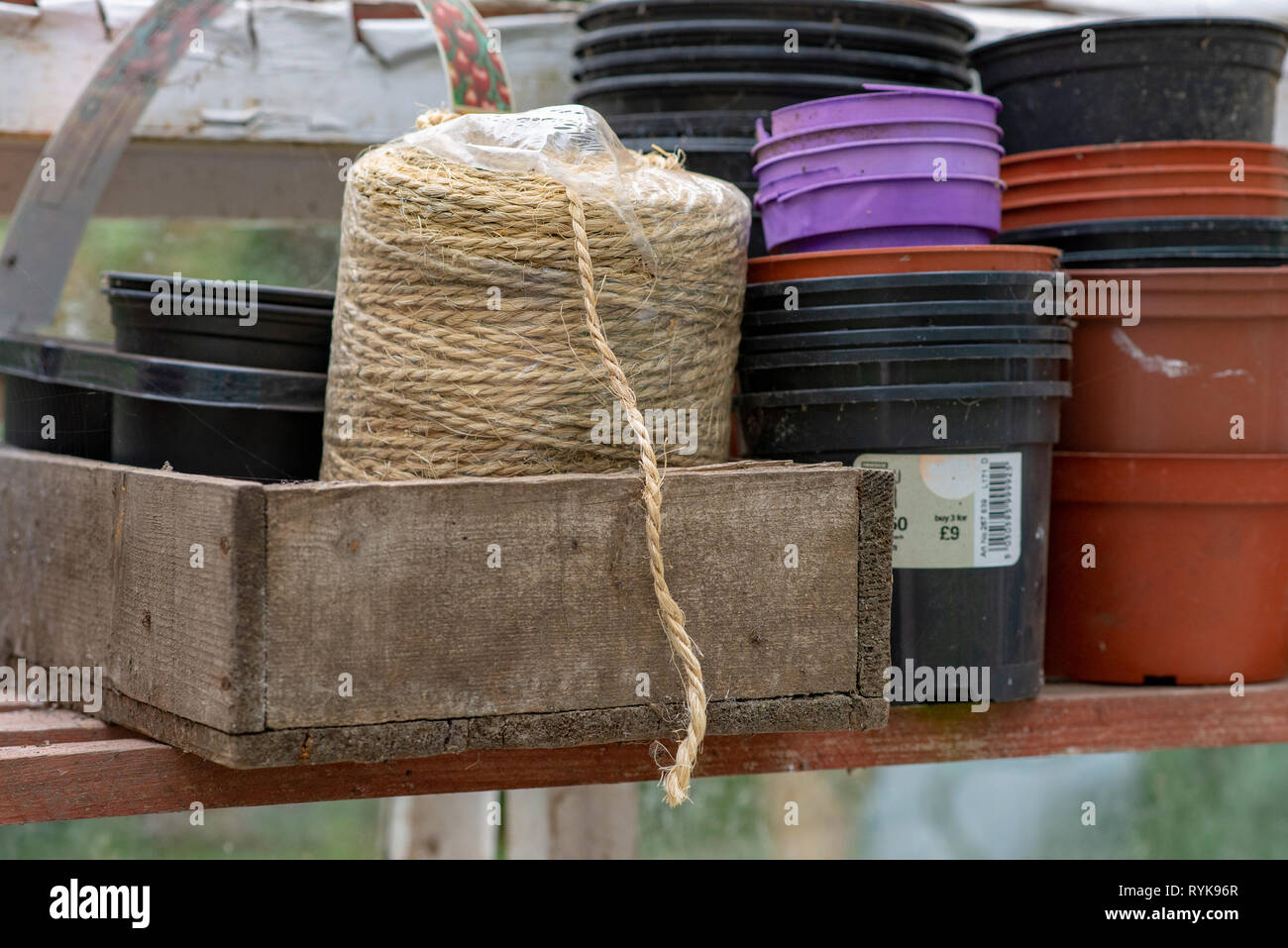 Garden string and plastic plant pots in a greenhouse, Chipping, Lancashire. Stock Photo