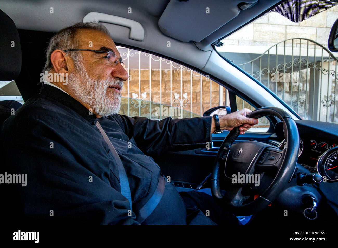 Melkite (Greek catholic) priest Emile Shoufani driving his car. Stock Photo