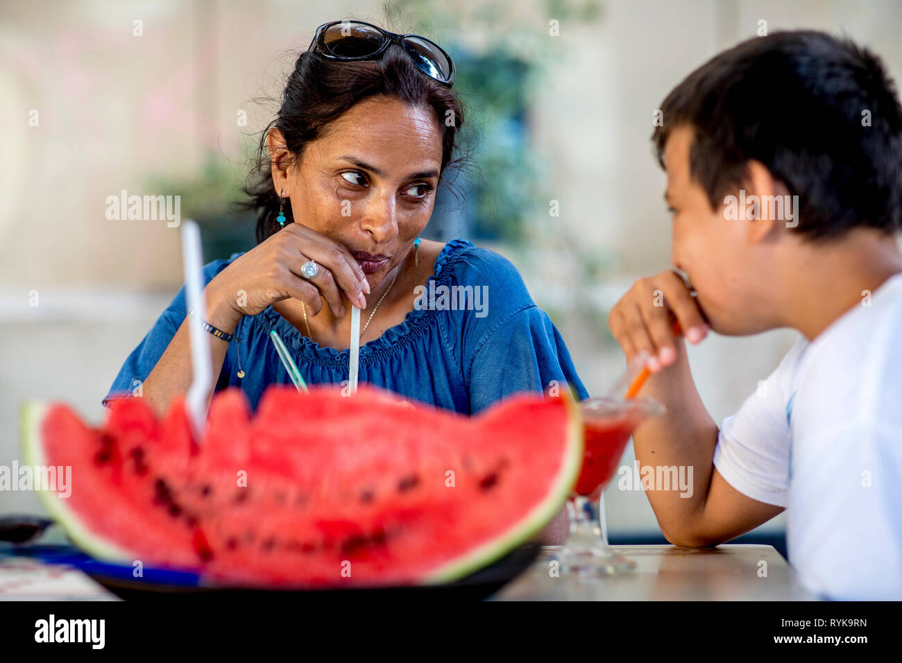 Mother and son drinking watermelon juice in Palermo, Sicily (Italy). Stock Photo