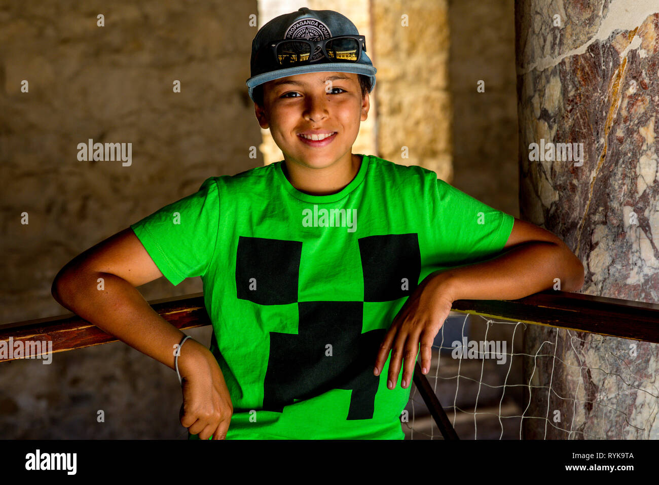 Smiling boy standing in the Villa Casale Roman villa in Sicily (Italy). Stock Photo