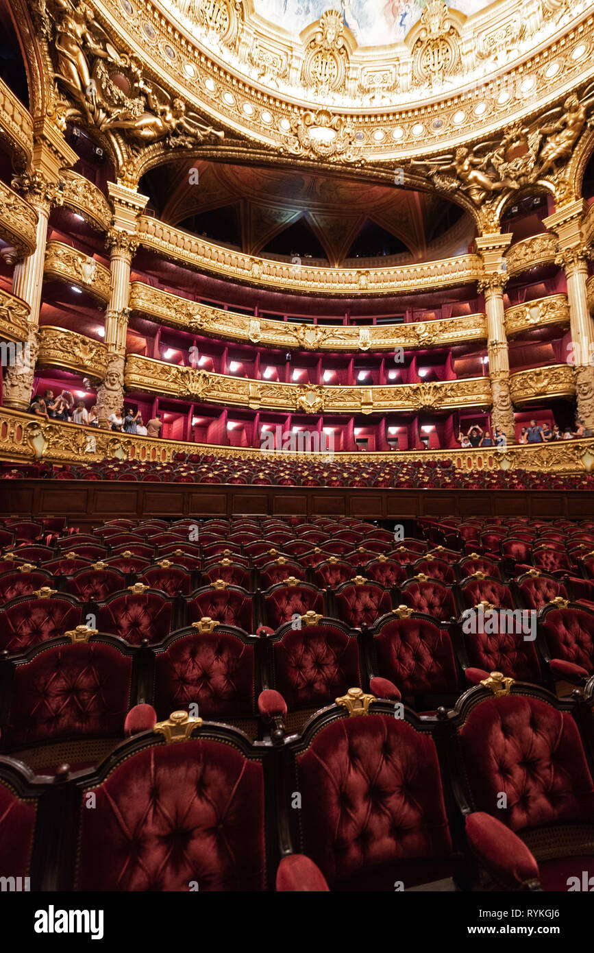 Paris (France): tourists visiting Palais Opera. Orchestra and balcony seats. The building is classified as a National Historic Landmark (French 'Monum Stock Photo