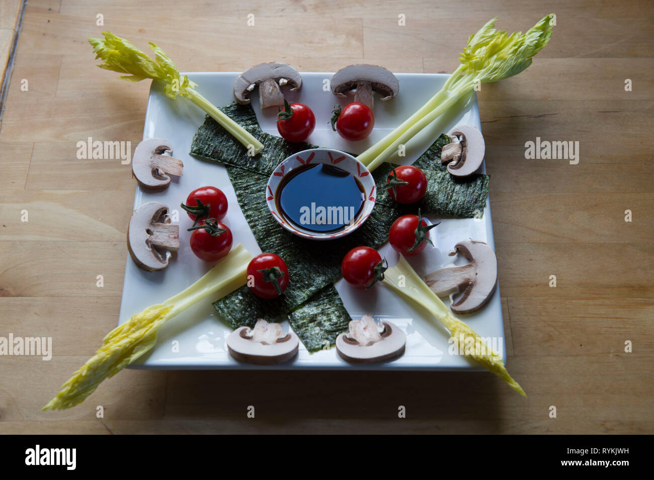 Umami ingredients displayed on plate including celery, mushrooms, miso, soy sauce -an ideal vegan meal high in glutamate, nutritious and flavoursome. Stock Photo