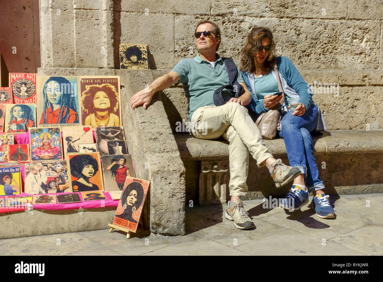 Spain Valencia tourists people sitting front of Cathedral Valencia Old Town Spain Carrer de Micalet street tourists sightseeing, pictures local artist Stock Photo