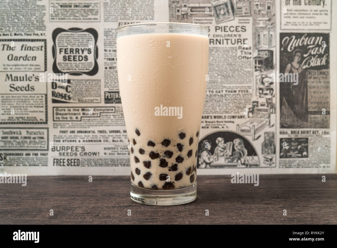 A glass cup of pearl milk tea (also called bubble tea) and a plate of  tapioca ball on white background. Pearl milk tea is the most representative  drin Stock Photo - Alamy