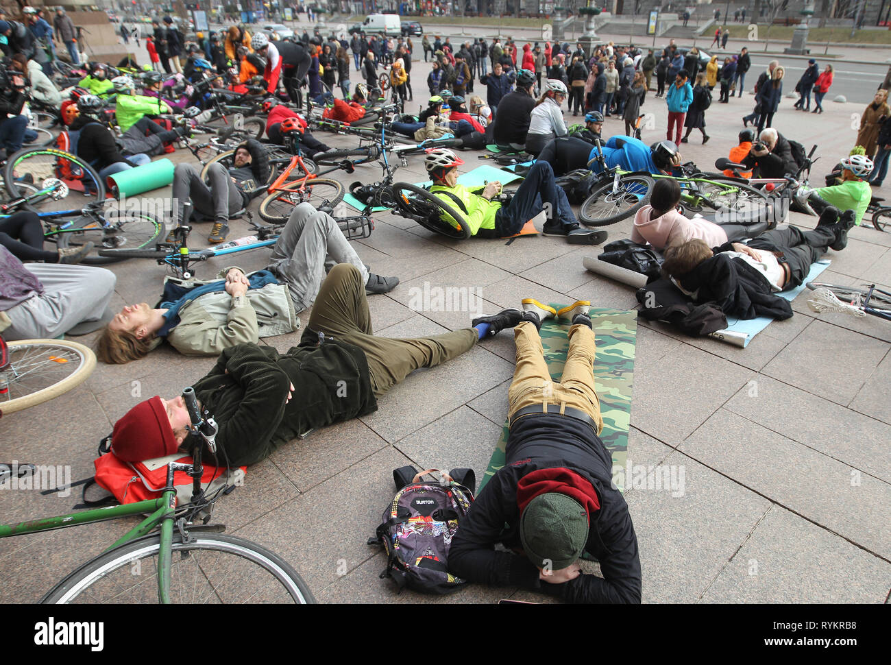 Cyclists seen laying on the ground with their bikes at the city hall during the protest. Cyclists demand for officials to announce tenders for bike routes and reduce the maximum allowed speed to 50 kilometers per hour for cars in the city. This ‘Die-In’ protest was connected to the death of an elderly cyclist, who was hit by a car at a bike lane in Kiev, according to activists. Stock Photo