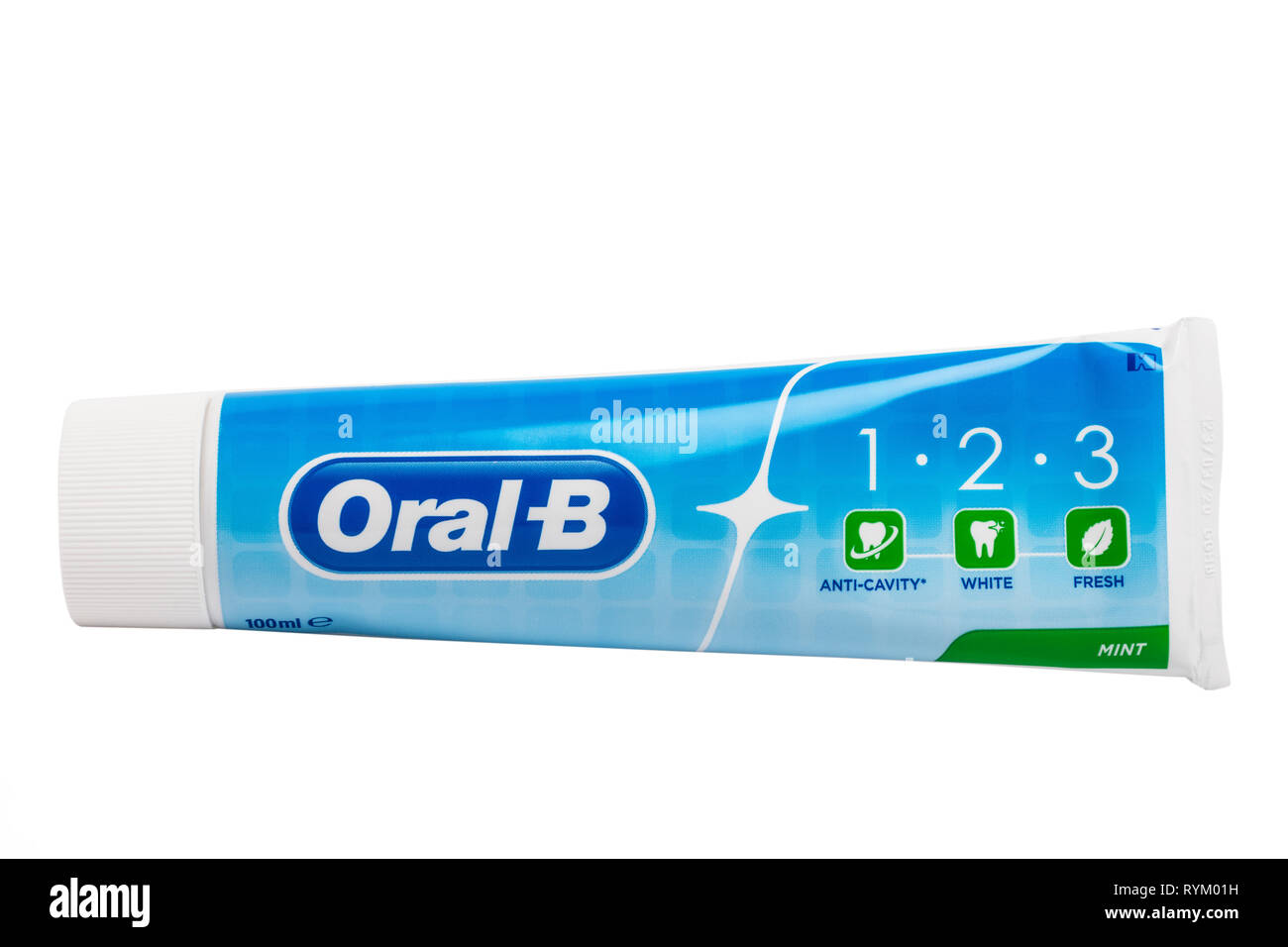 A tube of Oral-B mint toothpaste with active flouride on a white background Stock Photo