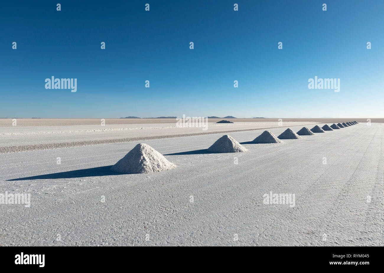 The salt pyramids of Colchani in the Salt Flat of Uyuni (Salar de Uyuni) where the salt is drying before further processing, Bolivia. Stock Photo
