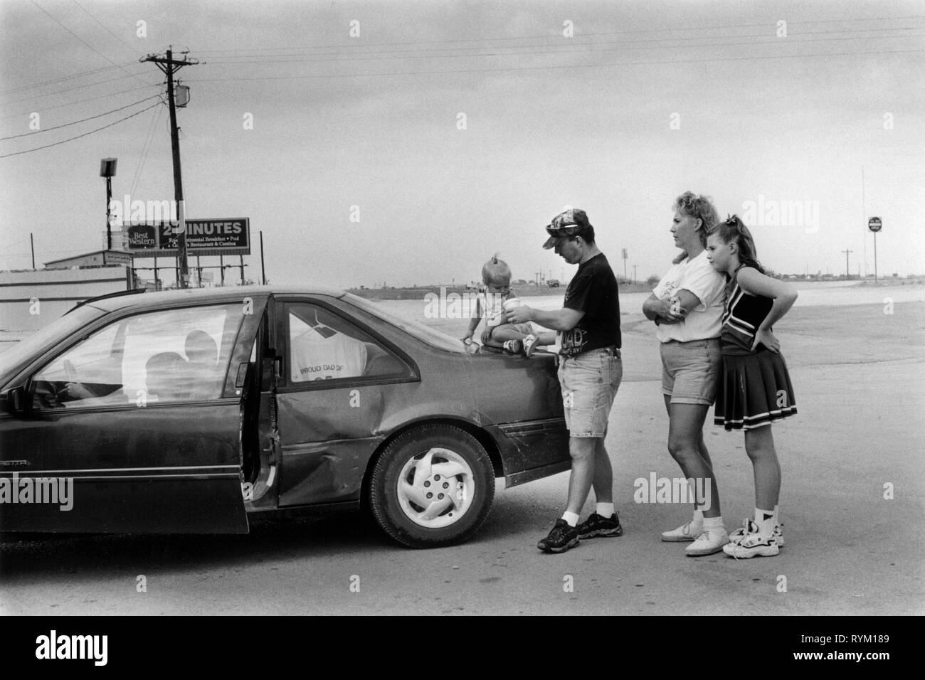 Decatur, Texas, USA 1990s. A young family wait for assistance in the