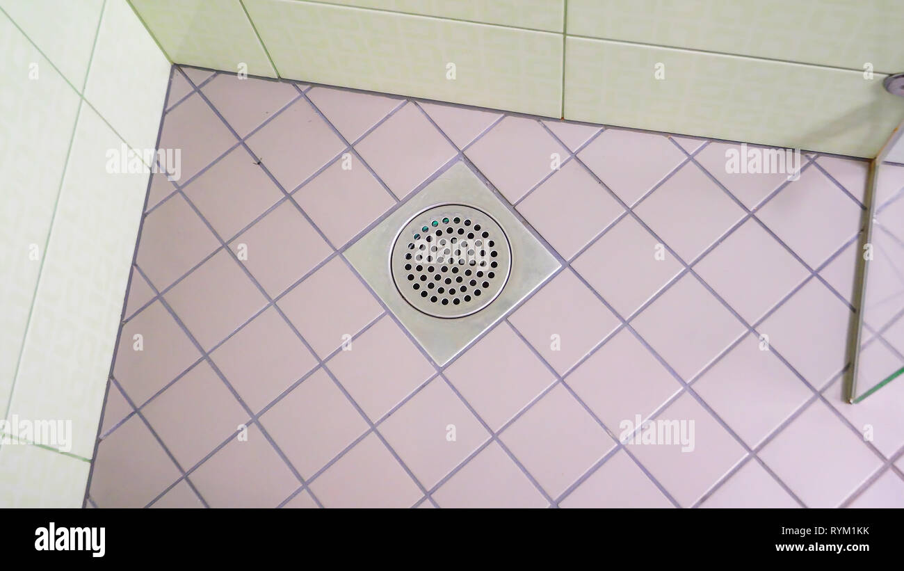 Closer look of the holes on the floor in the bathroom where water