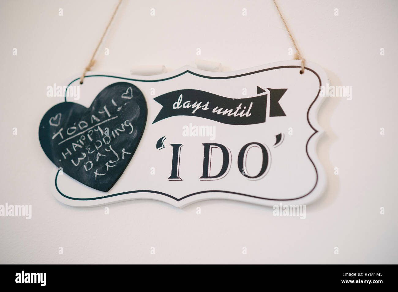 a wooden hanging sign countdown to wedding day. When locdown restrictions lifted england UK weddings Stock Photo