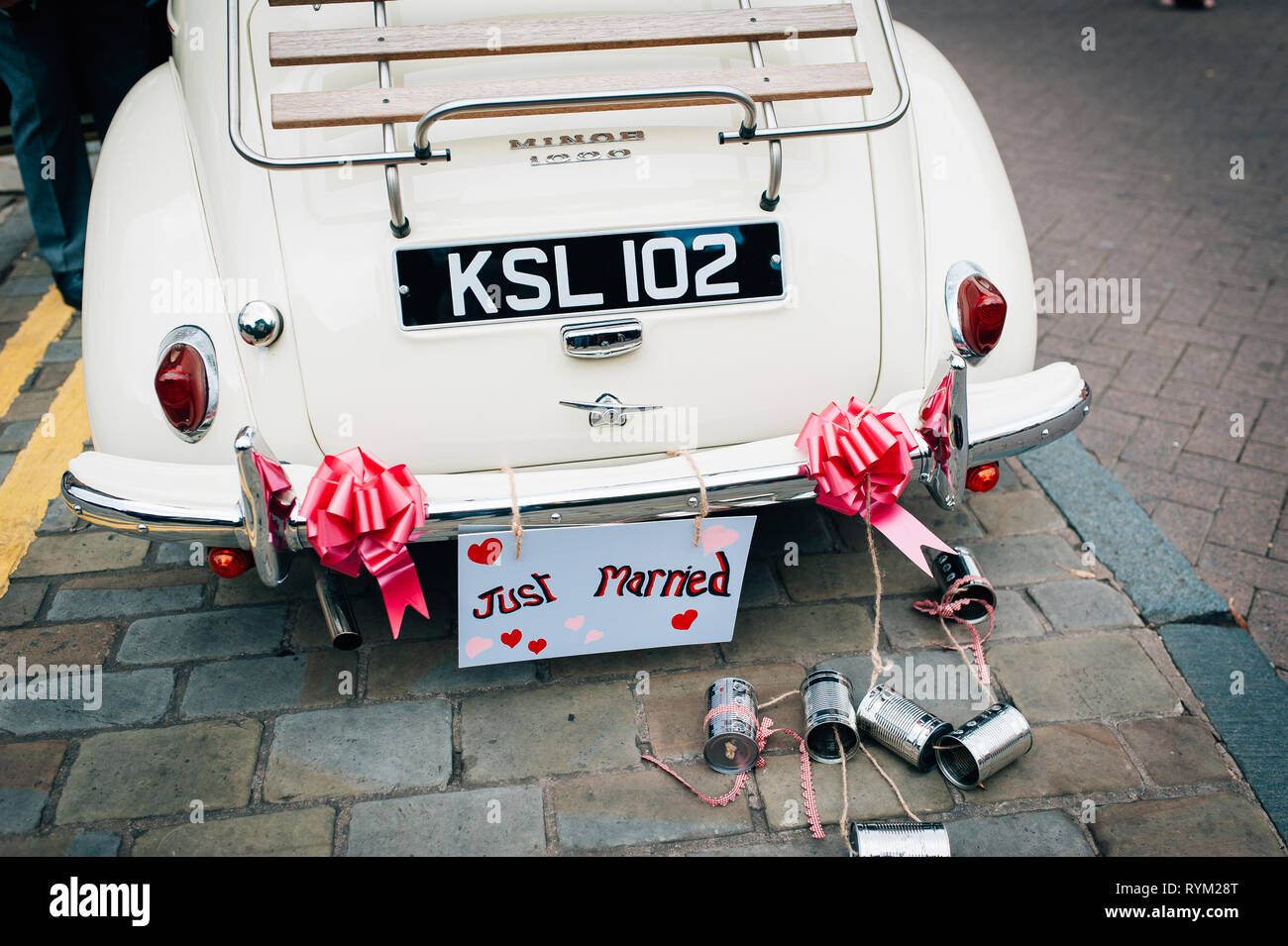 Newlyweds Waving In Convertible Car With Cans Attached To It Stock Photo -  Download Image Now - iStock